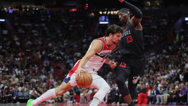Washington Wizards forward Deni Avdija (8) drives to the basket against Miami Heat center Bam Adebayo (13) during the second quarter at Kaseya Center.